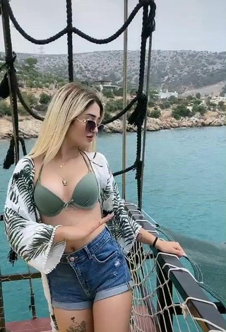 2. Irresistible Eda Aslankoç Shows Cleavage in Olive Bikini Top on a Boat