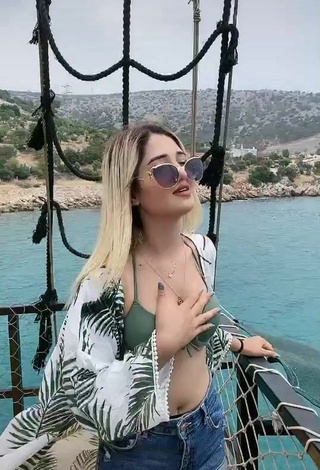 3. Irresistible Eda Aslankoç Shows Cleavage in Olive Bikini Top on a Boat