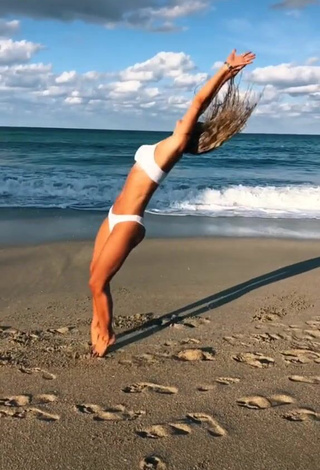 Gorgeous Olivia Dunne in Alluring White Bikini at the Beach while doing Fitness Exercises