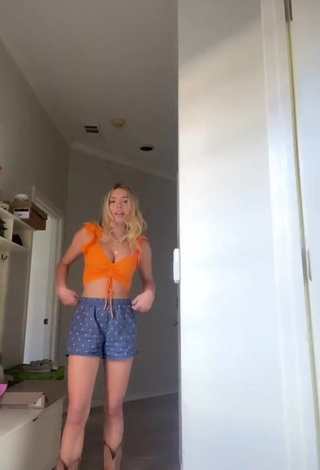 Irresistible Alex French Shows Cleavage in Orange Crop Top