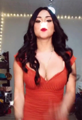 Erotic Ónice Flores Shows Cleavage in Orange Dress and Bouncing Breasts