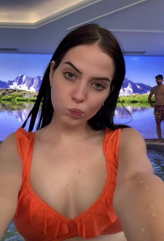 1. Erotic Sara Shows Cleavage in Orange Bikini Top at the Pool