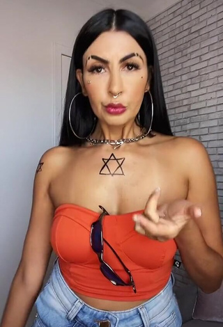 1. Erotic Sil Shows Cleavage in Electric Orange Tube Top