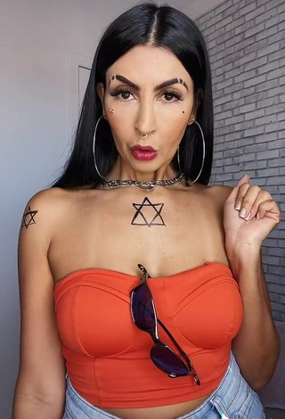 2. Erotic Sil Shows Cleavage in Electric Orange Tube Top