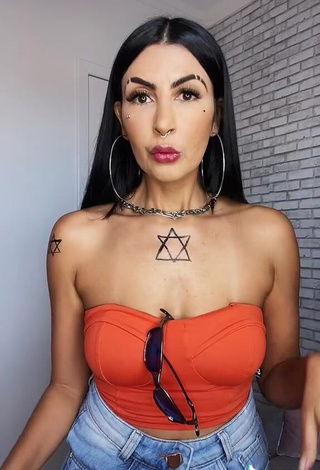 3. Erotic Sil Shows Cleavage in Electric Orange Tube Top