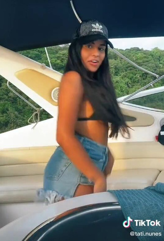 Cute Tati Nunes Shows Cleavage in Black Bikini Top on a Boat