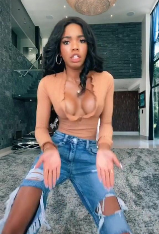 3. Erotic Teala Dunn Shows Cleavage in Peach Top