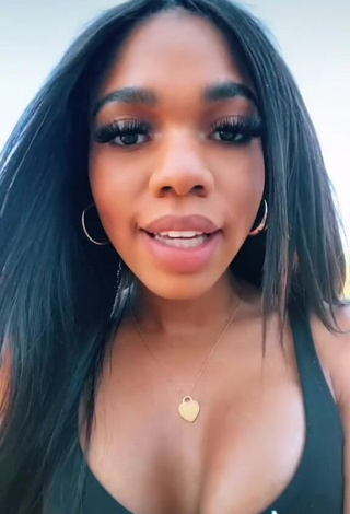 2. Irresistible Teala Dunn Shows Cleavage in Black Top