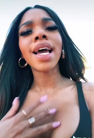 3. Irresistible Teala Dunn Shows Cleavage in Black Top