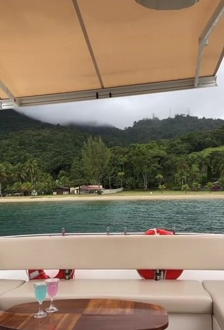 Lovely Marina Ferrari Shows Cleavage in Bikini on a Boat