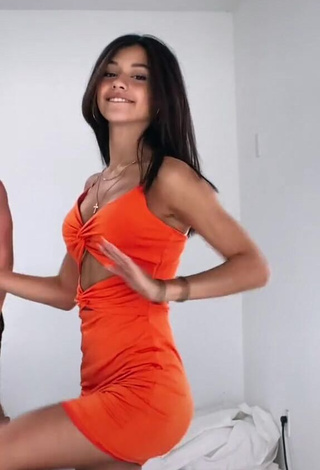 Erotic Rachel Brockman Shows Cleavage in Orange Dress