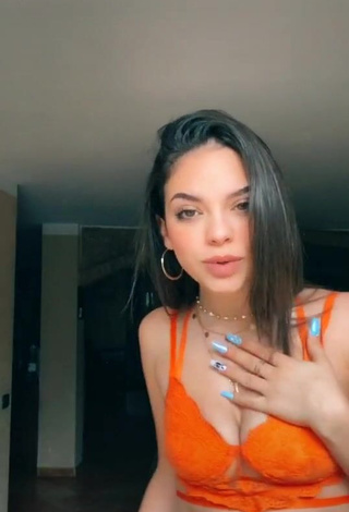 2. Erotic Giulia Paglianiti Shows Cleavage in Electric Orange Bra