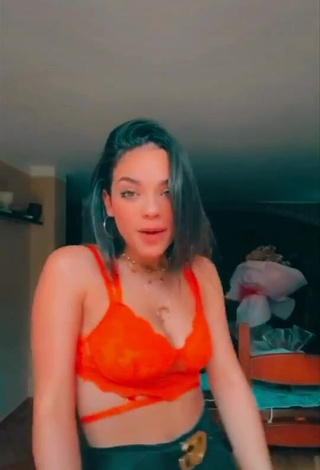 3. Irresistible Giulia Paglianiti Shows Cleavage in Electric Orange Bra