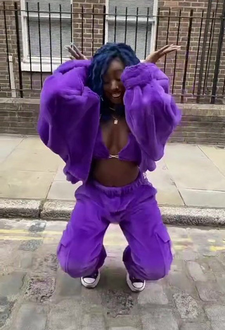 3. Erotic Oluwanifewa Agunbiade Shows Cleavage in Violet Bikini Top in a Street