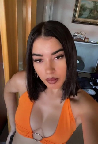 2. Amazing Kiara Brunett Shows Cleavage in Hot Orange Crop Top