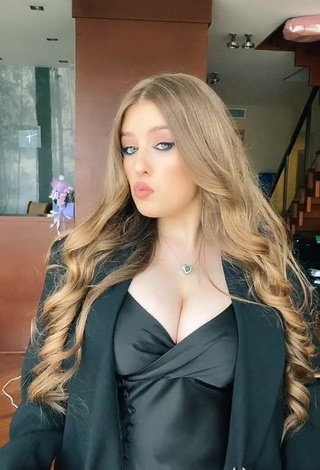 Erotic Viktoria Nikulina Shows Cleavage in Black Dress