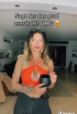 2. Cute Aline Jost Shows Cleavage in Orange Crop Top (Side Boob)