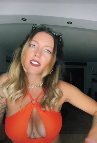 1. Captivating Aline Jost Shows Cleavage in Orange Crop Top (Side Boob)