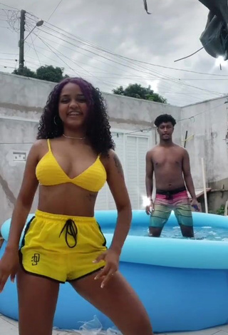 3. Erotic Radija Pereira Shows Cleavage in Yellow Bikini Top