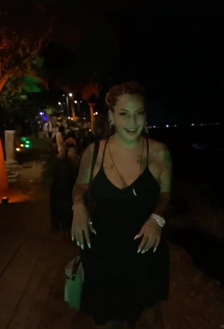 2. Erotic ingizem34 Shows Cleavage in Black Dress in a Street