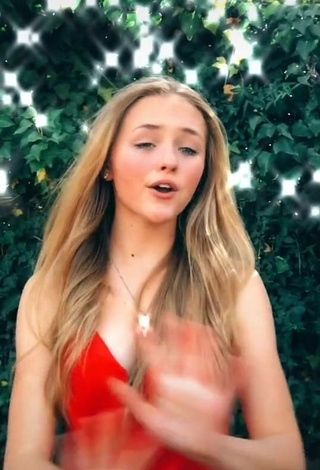 Erotic Bella Messens Shows Cleavage in Red Dress