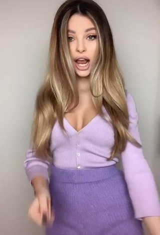 Erotic Valerie Lungu Shows Cleavage in Violet Top