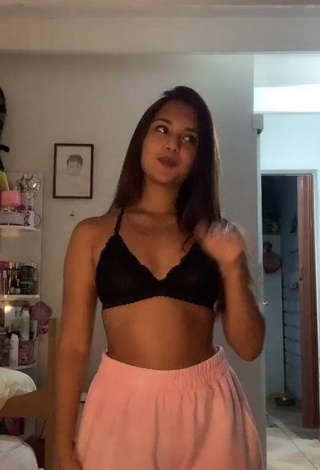 Erotic Yess Shows Cleavage in Black Bra