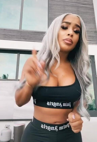 1. Irresistible DreamDoll Shows Cleavage in Black Crop Top