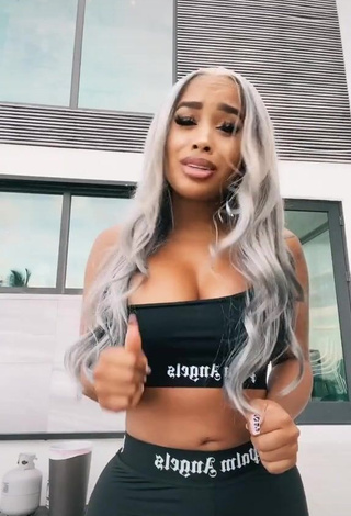 3. Irresistible DreamDoll Shows Cleavage in Black Crop Top