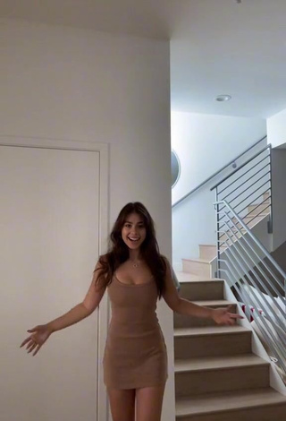 Erotic Emily Alexander Shows Cleavage in Beige Dress