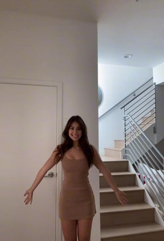 3. Erotic Emily Alexander Shows Cleavage in Beige Dress