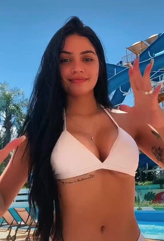 Erotic Henny Shows Cleavage in White Bikini
