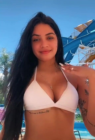 3. Erotic Henny Shows Cleavage in White Bikini