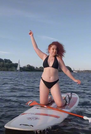 Erotic Elizaveta Strizh Shows Cleavage in Black Bikini in the Sea