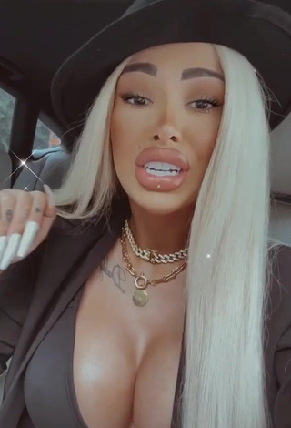 Erotic Cristina Pucean Shows Cleavage in Black Crop Top in a Car