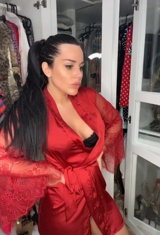 Erotic Laura Lempika Shows Cleavage in Red Bathrobe