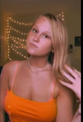 3. Hot Caiti Mackenzie Shows Cleavage in Orange Crop Top