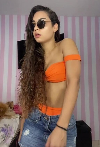 Captivating Ingrid Muniz Shows Cleavage in Orange Bikini Top