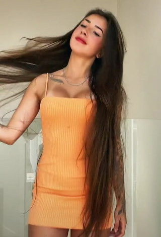 2. Irresistible Julieta Shows Cleavage in Orange Dress