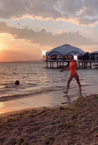 1. Erotic Diana Belitskay in Orange Bodysuit at the Beach