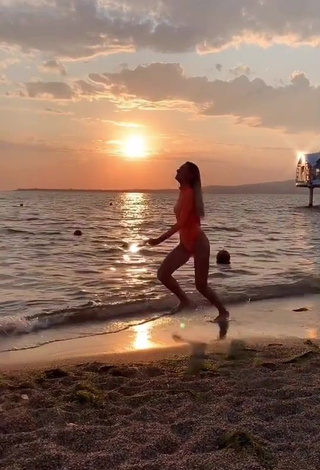 3. Erotic Diana Belitskay in Orange Bodysuit at the Beach