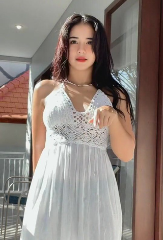 Erotic Angguncantik Shows Cleavage in White Dress