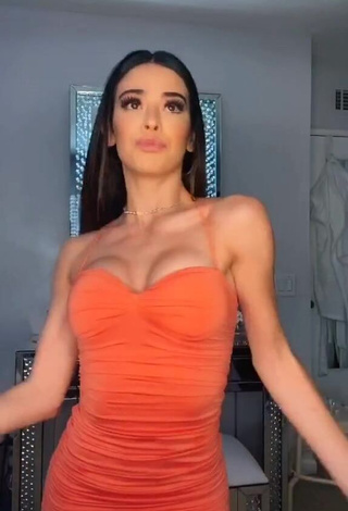 Irresistible Lauren Kettering Shows Cleavage in Orange Dress