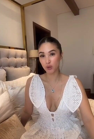 Erotic Heart Evangelista Shows Cleavage in White Dress