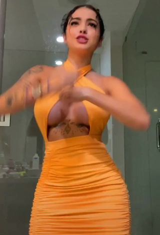 Erotic Malu Trevejo Shows Cleavage in Orange Dress