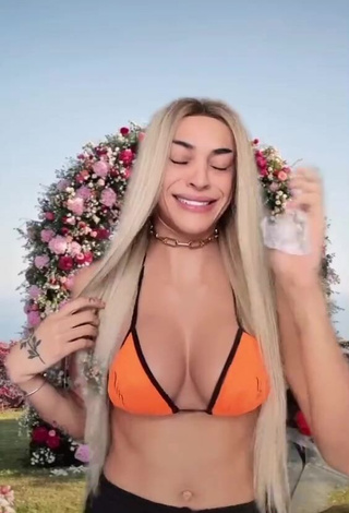 Erotic Pabllo Vittar Shows Cleavage in Orange Bikini Top