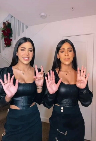 Erotic Melanie & Meila Shows Cleavage in Black Bodysuit