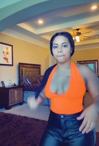 1. Irresistible Carmen Pritchett Shows Cleavage in Electric Orange Top