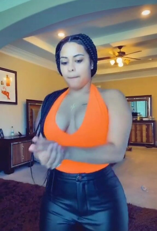 3. Irresistible Carmen Pritchett Shows Cleavage in Electric Orange Top